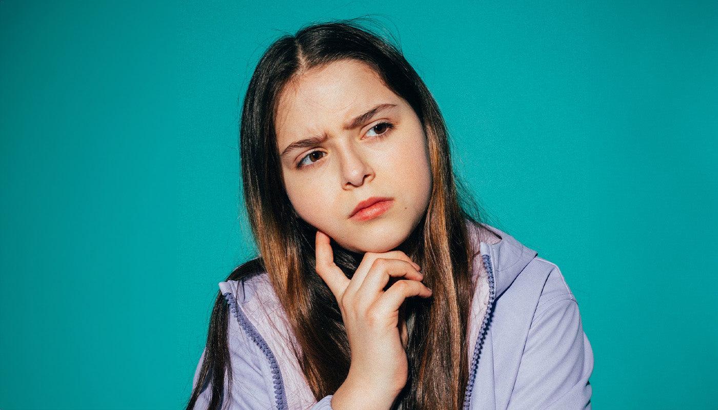 Image of Young woman in Entrusted to Him Christian streetwear at a crossroads — representing persistent faith, the call of Luke 18:8, and the choice to stand for what is true in a world that rewards compromise