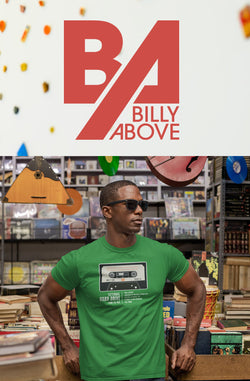 Image of A man leaning and wearing a green shirt with an old cassette tape.