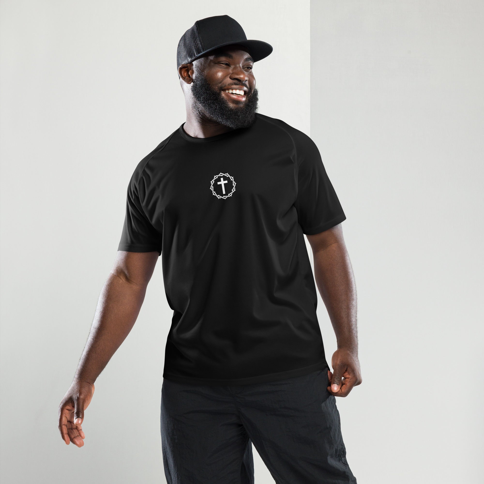 A man wearing a performance shirt with a cross and crown.