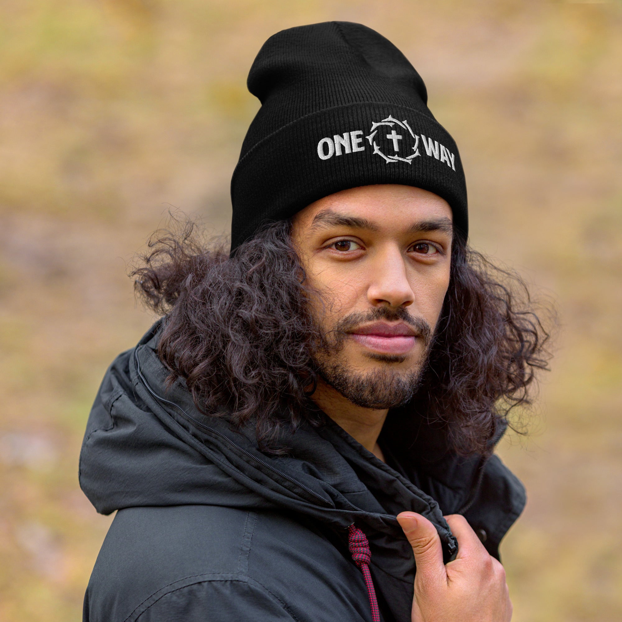 Image of Man wearing the One Way embroidered cuffed beanie in black outdoors
