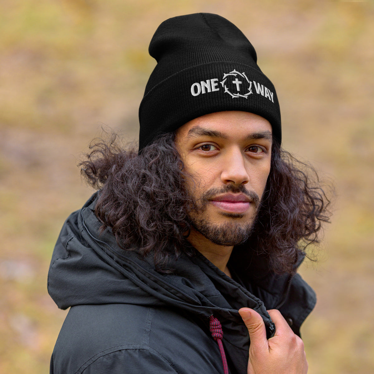 Man wearing the One Way embroidered cuffed beanie in black outdoors