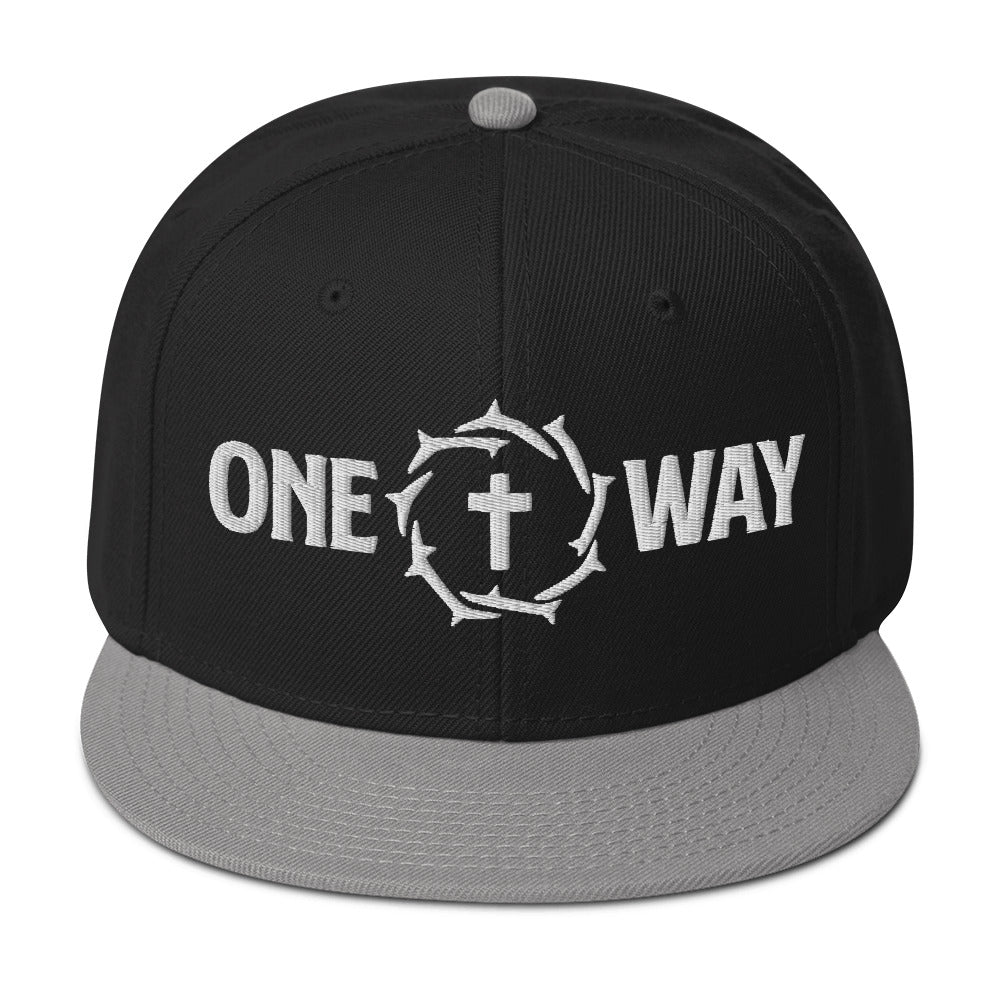 Image of One Way embroidered snapback hat in black with gray visor, showing the cross and crown of thorns design, front view