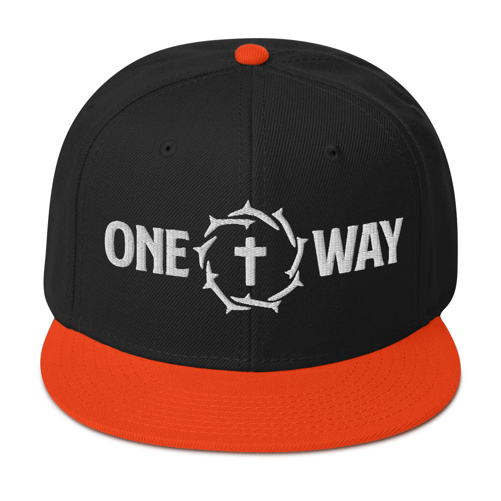 One Way embroidered snapback hat in black with orange visor, showing the cross and crown of thorns design, front view