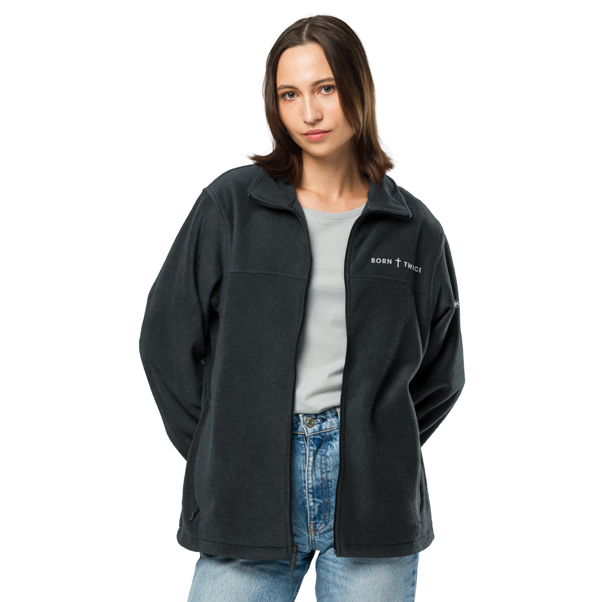Woman wearing the Born Twice Columbia fleece jacket in black, unzipped over a gray tee and jeans