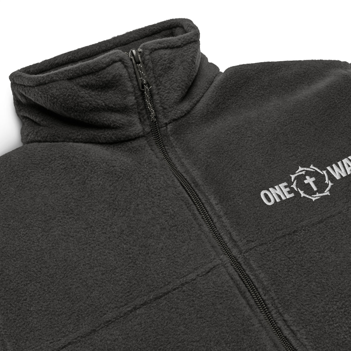 Close-up of the embroidered ONE WAY cross and crown of thorns, zipper and fleece collar on the charcoal heather Columbia jacket