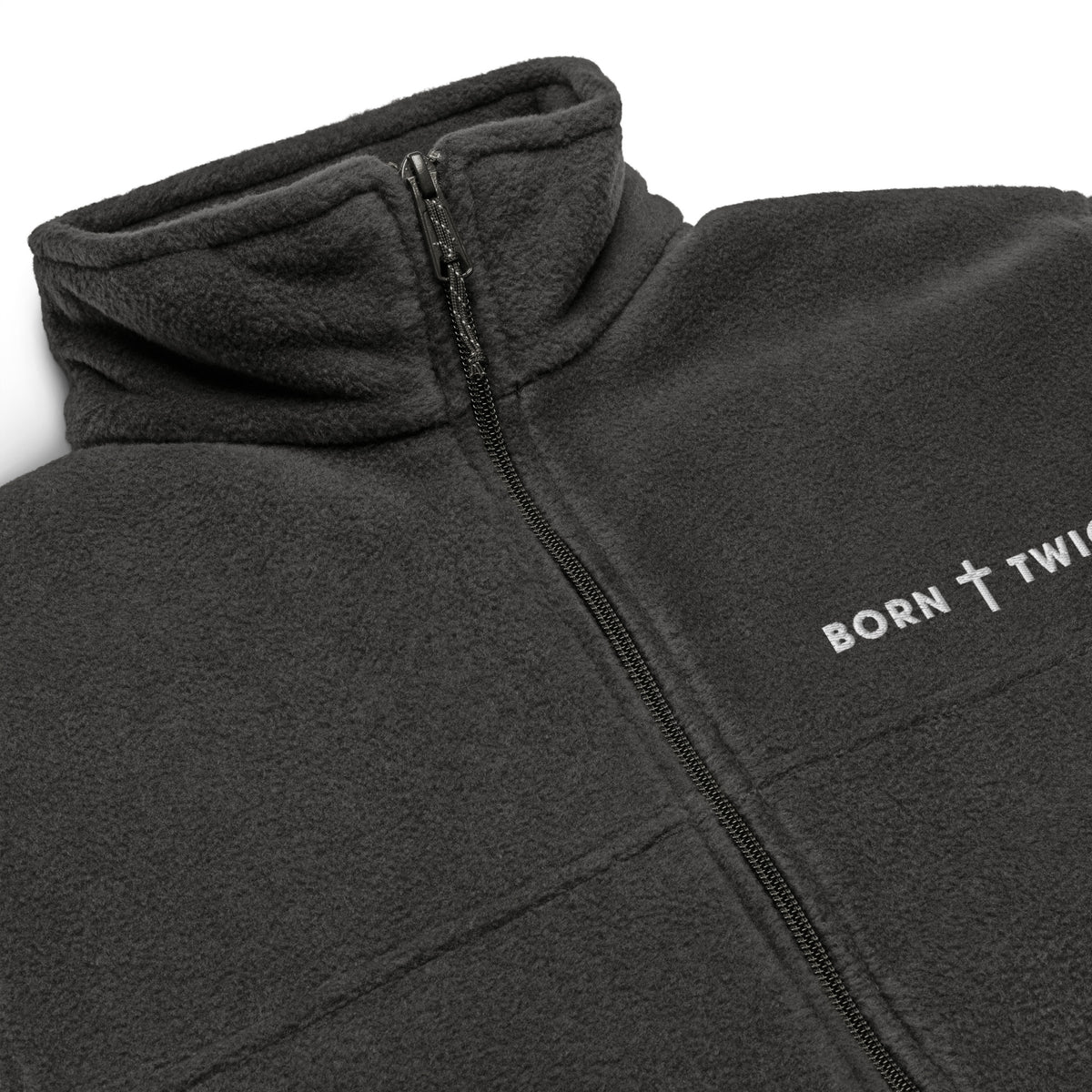 Close-up of the embroidered BORN TWICE cross wordmark, zipper and fleece collar on the charcoal heather Columbia jacket