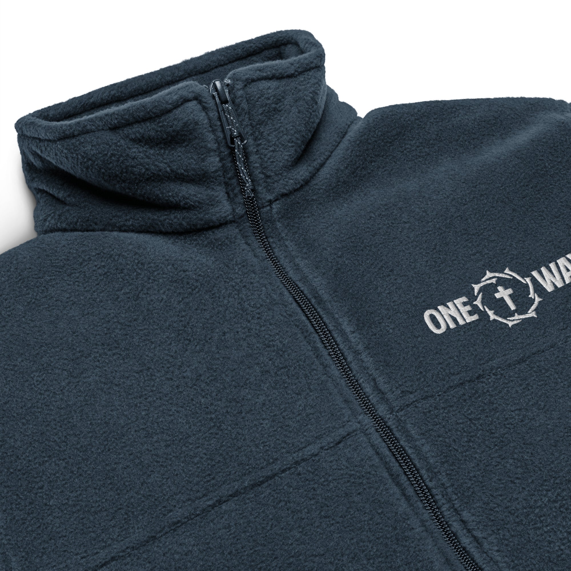 Image of Close-up of the embroidered ONE WAY cross and crown of thorns, zipper and fleece collar on the collegiate navy Columbia jacket
