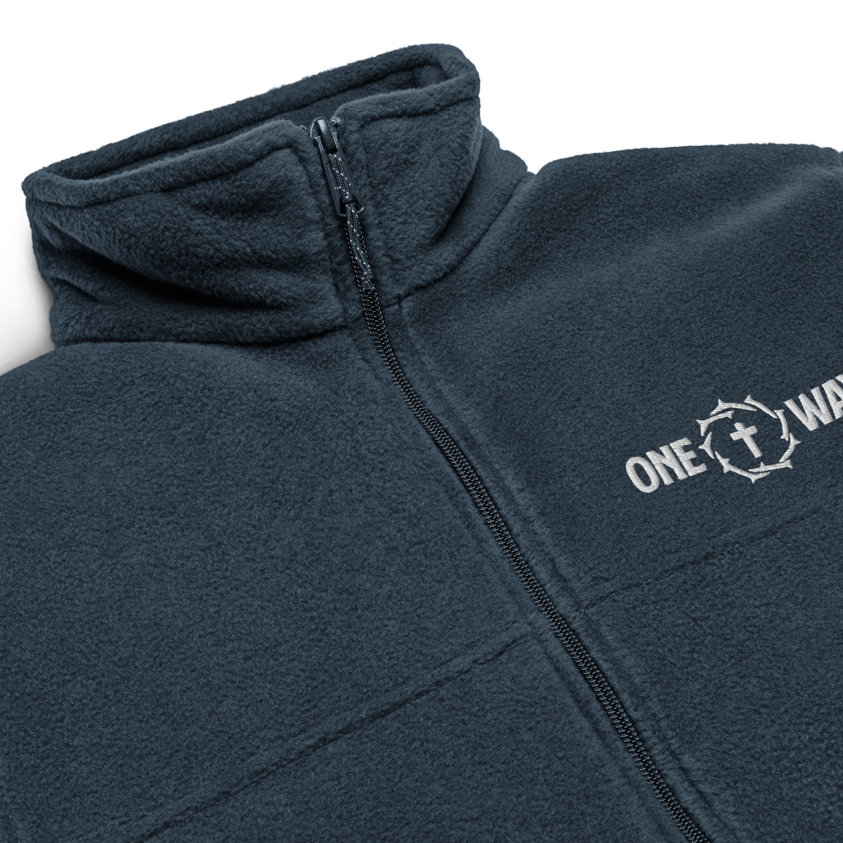 Close-up of the embroidered ONE WAY cross and crown of thorns, zipper and fleece collar on the collegiate navy Columbia jacket