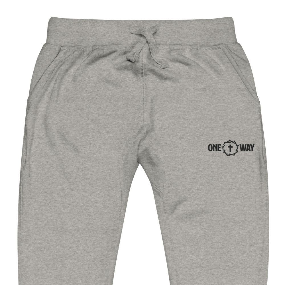 Close-up of the waistband, drawstring and logo on the One Way fleece sweatpants in carbon grey