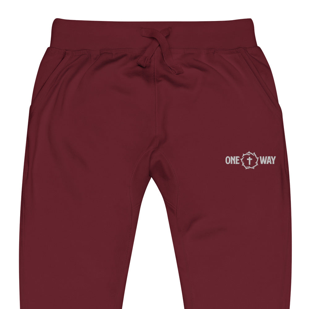 Close-up of the waistband, drawstring and logo on the One Way fleece sweatpants in maroon