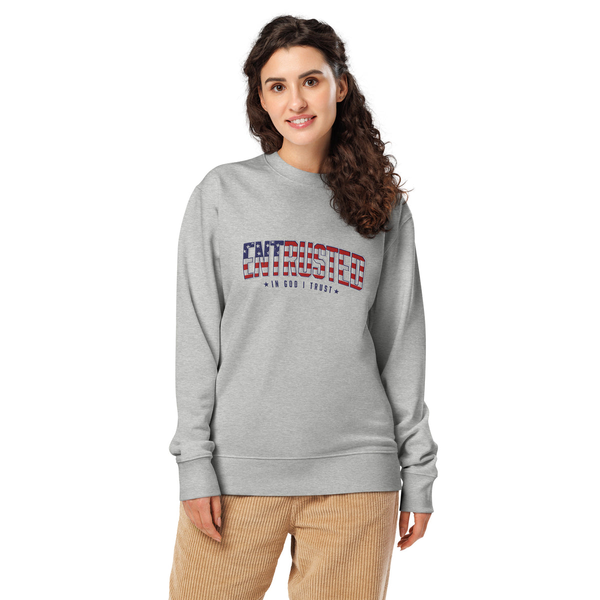 Woman wearing the Heather Grey Entrusted patriotic embroidered sweatshirt with corduroy pants, front view