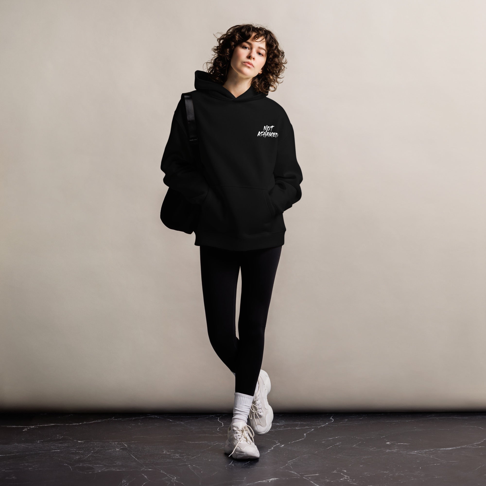 Image of Not Ashamed oversized Christian streetwear hoodie black front styled — Entrusted to Him